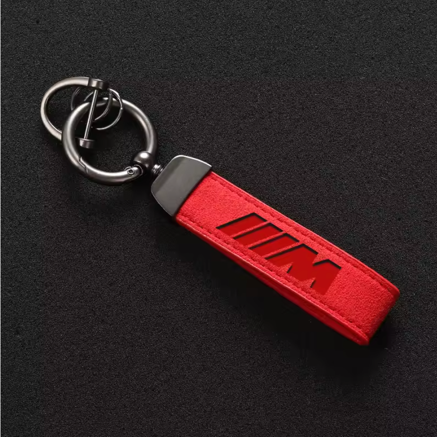 Premium red M-logo leather keychain with stitched edges and heavy-duty metal hardware, perfect for car enthusiasts and accessories.