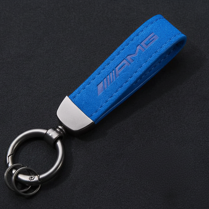 Blue AMG keychain on a black background