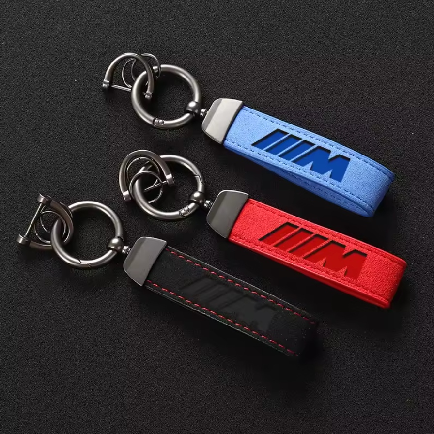 Stylish leather M-logo keychains in blue, red, and black with durable metal rings, ideal for car accessories and gifts.